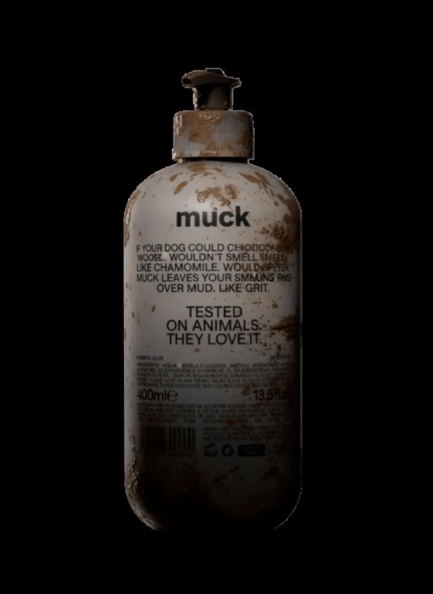 Back label of the bottle, mud-flecked, carrying the product copy and the line Tested on animals. They love it.