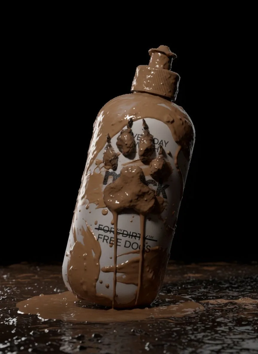 The bottle standing in mud with a set of wet paw prints running down the front label.